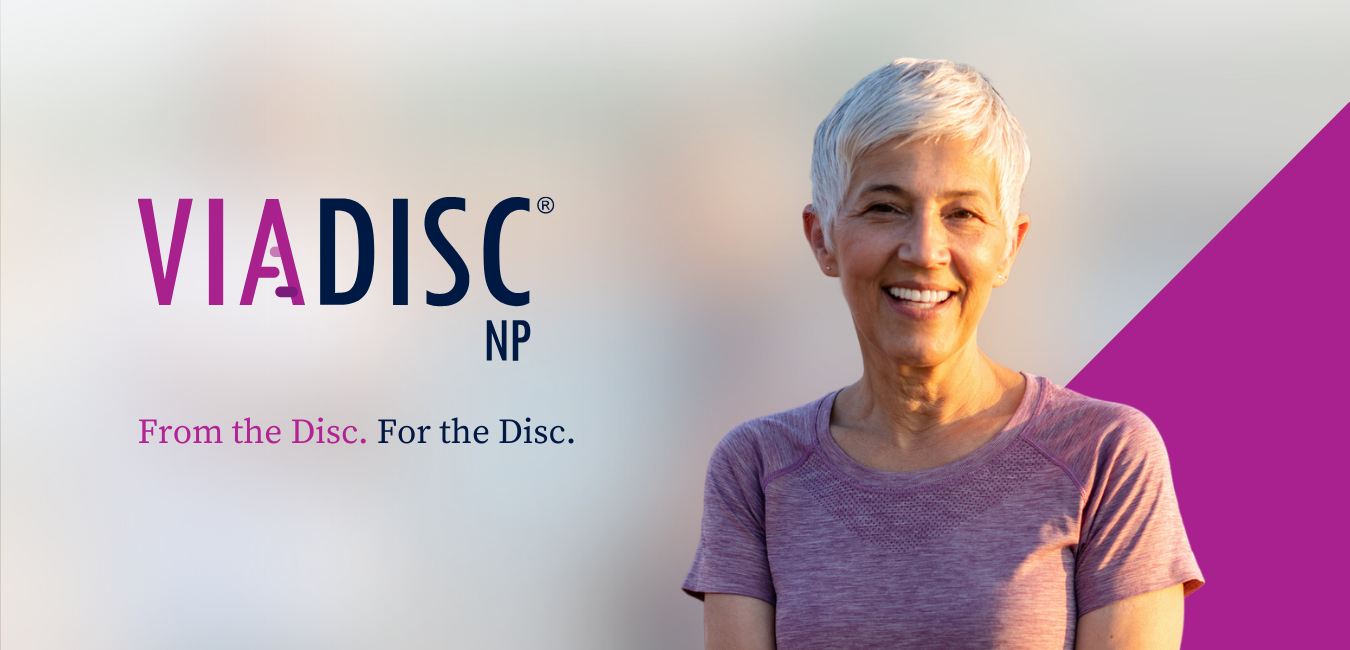 happy, elderly woman wearing magenta, pain-free after VIA DISC NP treatment